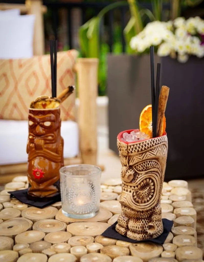 Tropical tiki cocktails with cinnamon and citrus garnish